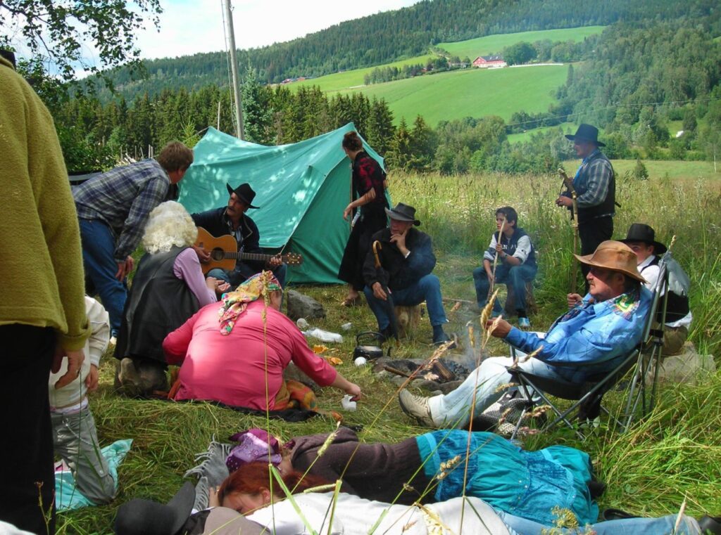 Travelers (tinkers, gypsies) outside their tent, during a festival.