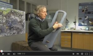 Graeme Lawson with his lyre replica (YouTube).